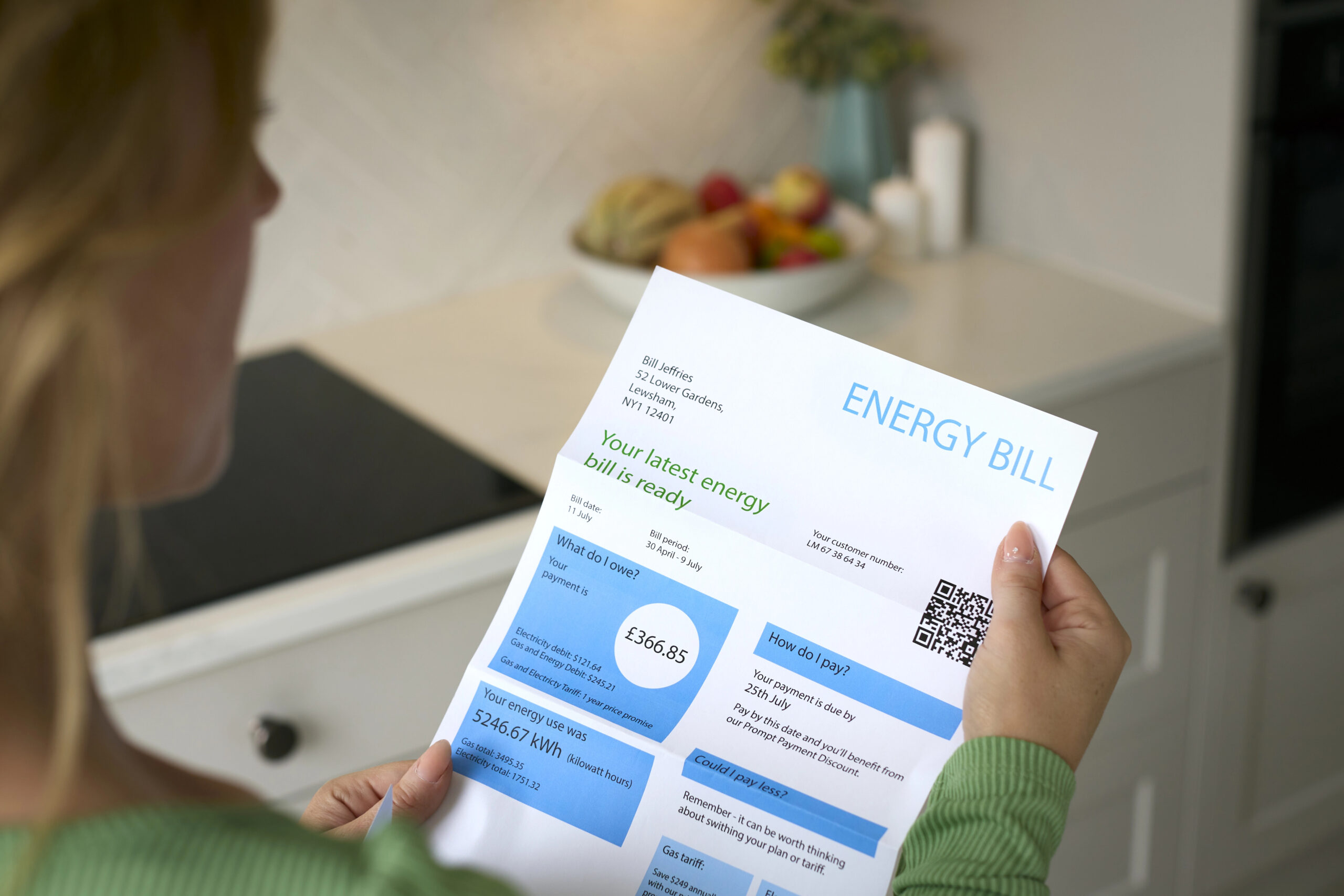 Woman holding energy bill with unclear charges and fees