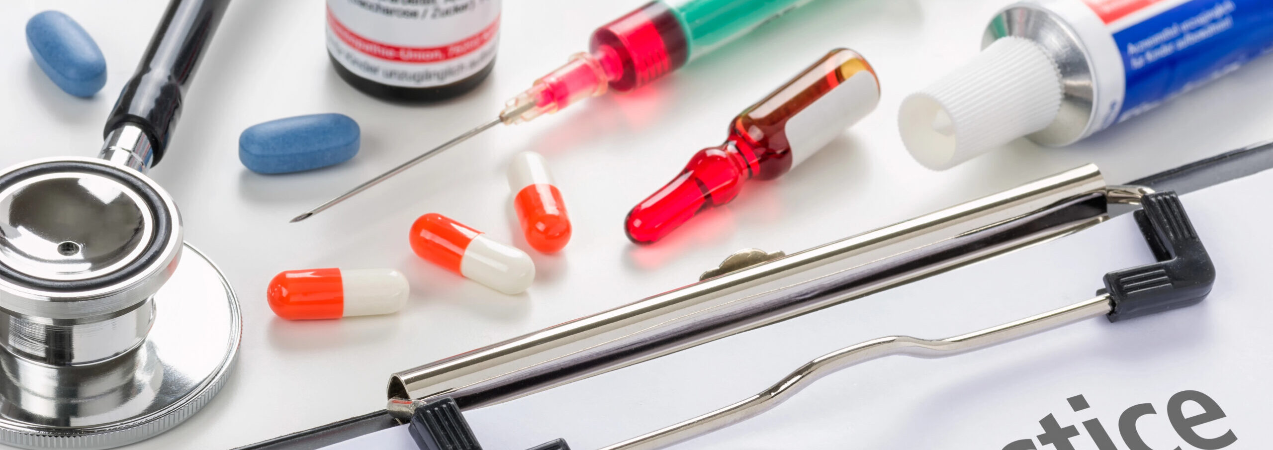 Medical negligence document on clipboard with medication and stethoscope