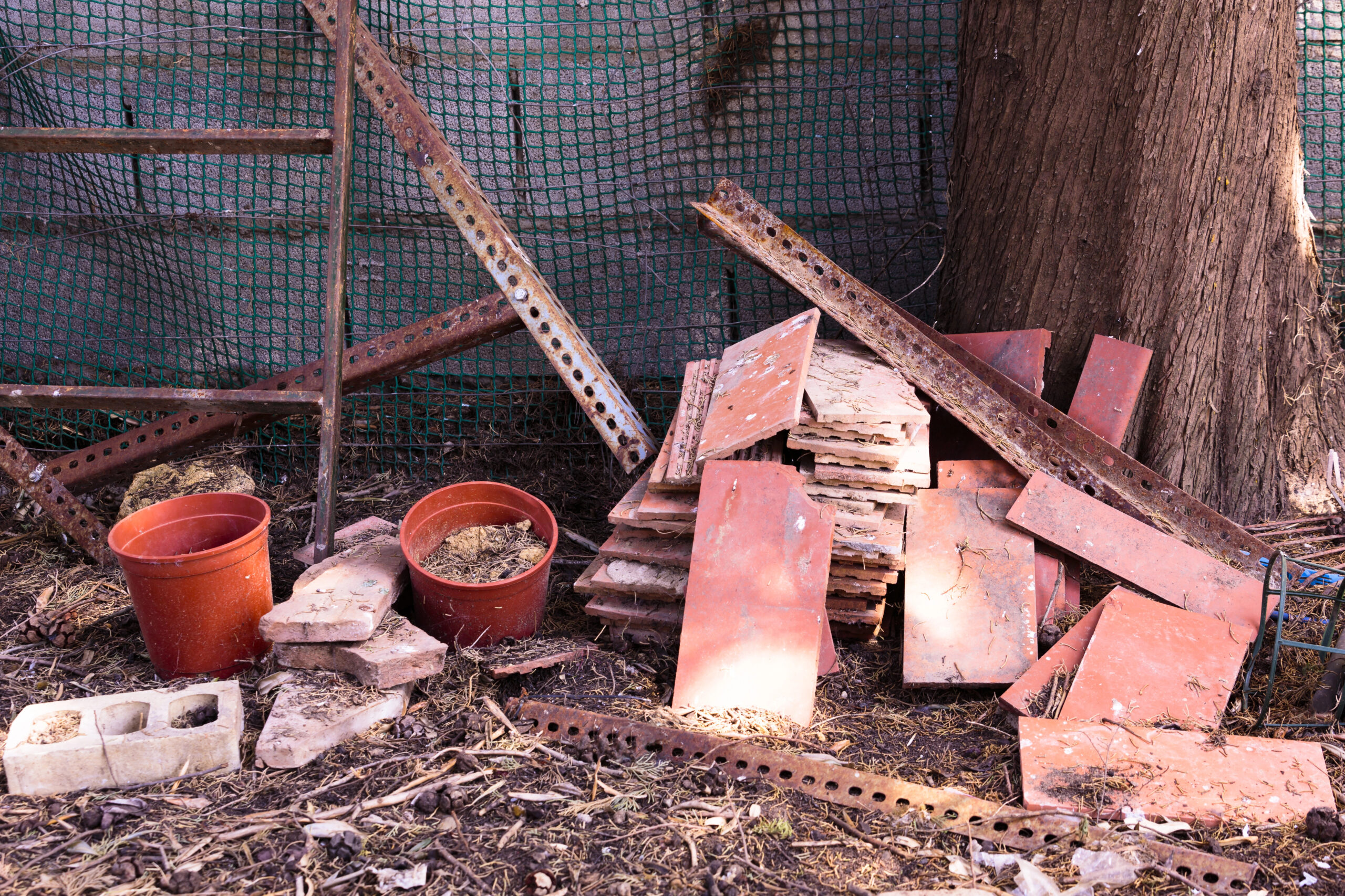 Rusty metal and bricks scattered on contaminated land
